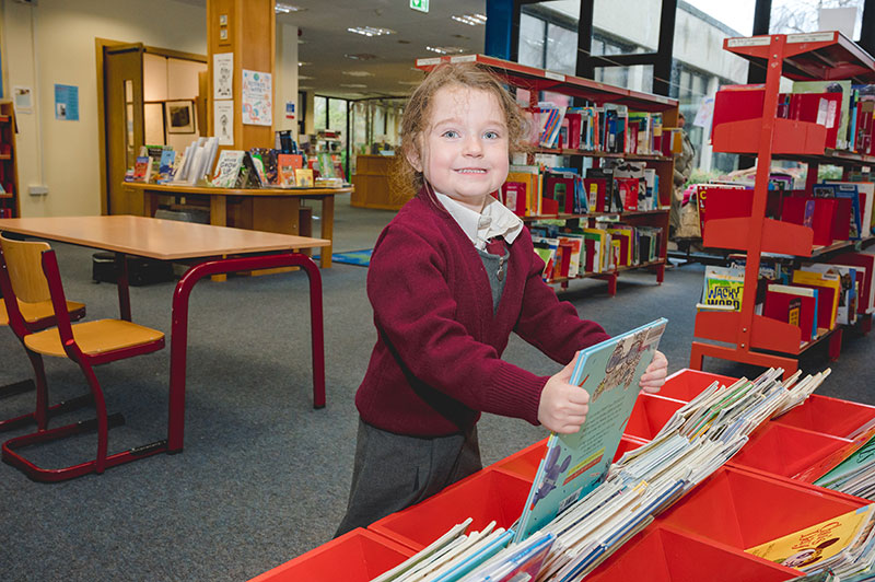 Moyderwell Mercy National School student with book in school library